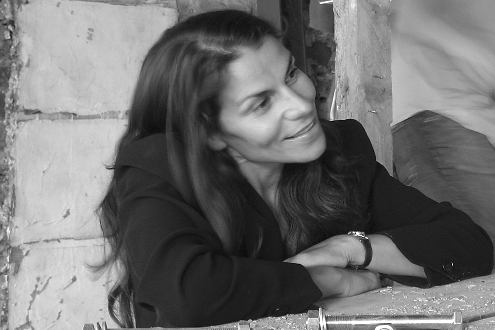 Photo of Marie Louise Jones smiling and leaning in as she discusses art
